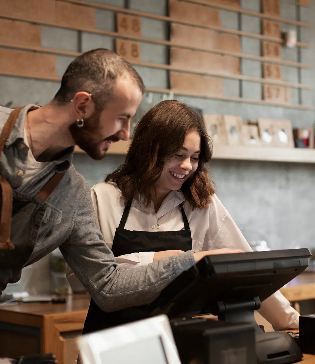 Café staff using a POS system for payment